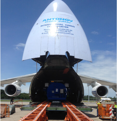 Heavy cargo being loaded into an Antonov aircraft for international transportation.