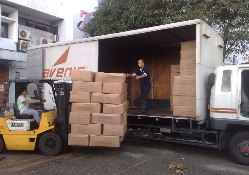 Forklift loading boxes into an Avenir Logistics truck for delivery in Singapore.