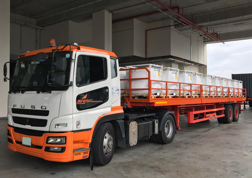 Avenir Logistics FUSO truck delivering goods in Singapore warehouse facility.