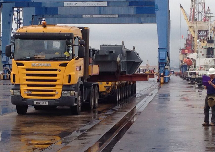 Heavy haulage truck transporting cargo at Jurong Port, Singapore.